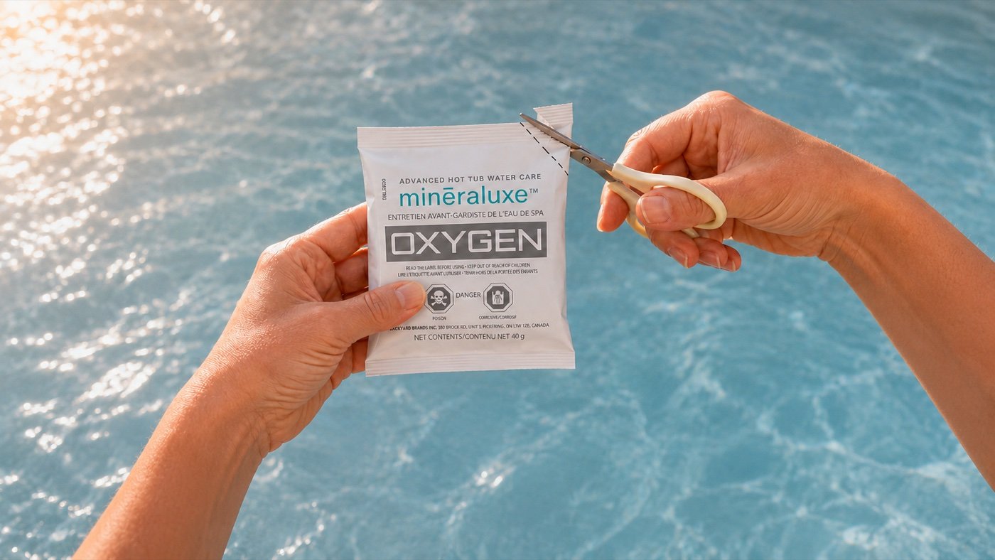 Hands cutting open a water care packet over a pool