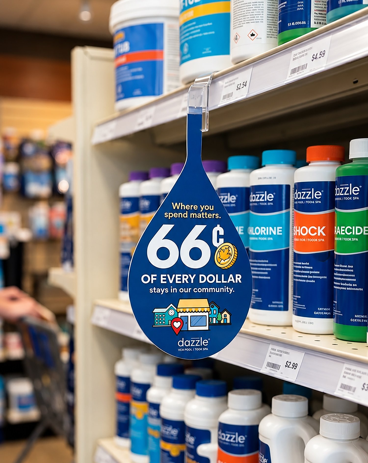 Dazzle &ldquo;Where you spend matters&rdquo; shelf dangler on a retail pool-care aisle